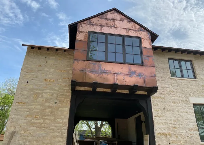 Copper metal panel facade on a stone building for Skylight Installation in Valley Falls