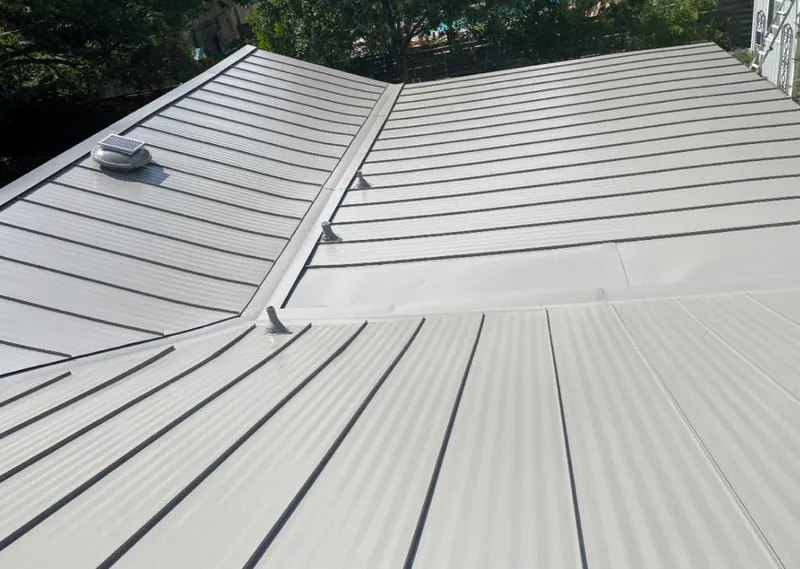 Solar attic fan installed on a metal roof for Roof Ventilation in Valley Falls